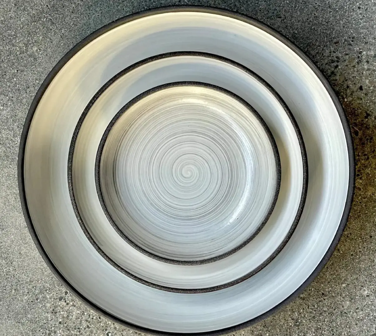 A white plate with two smaller plates on top of it.