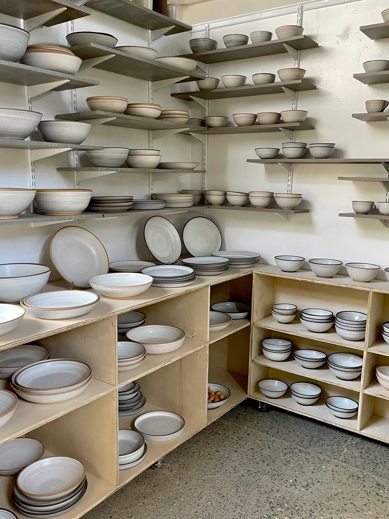 A room filled with shelves full of plates and bowls.