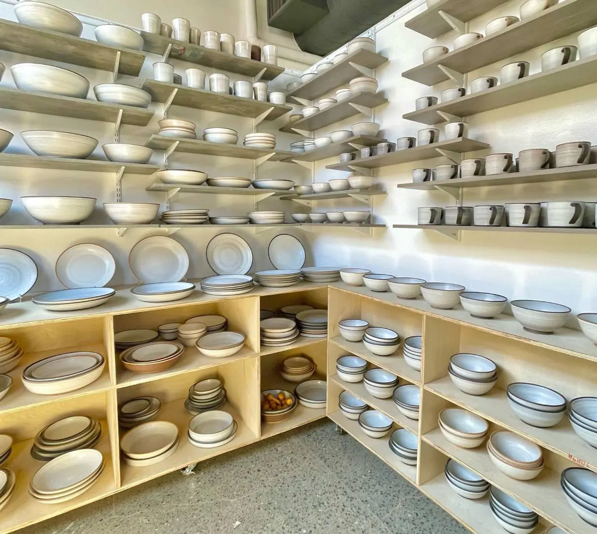 A room filled with lots of shelves full of plates.