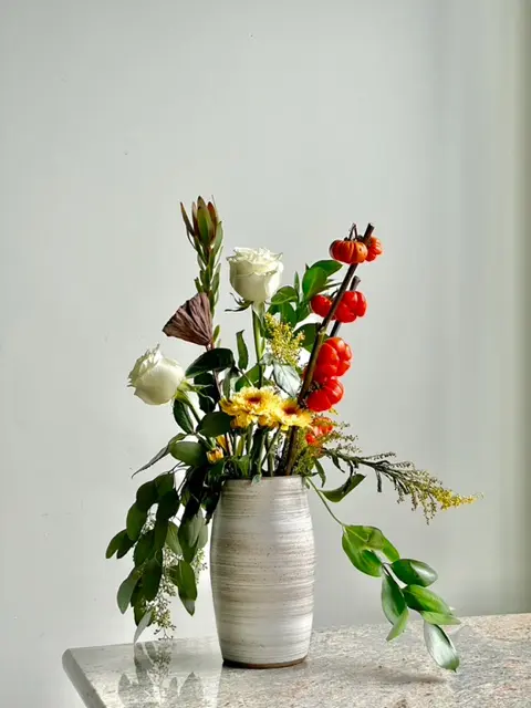 A vase filled with flowers on top of a table.